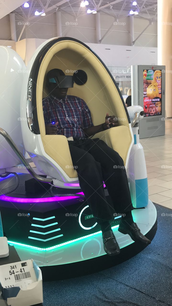 Playing A Virtual Reality Simulator Game @ A Mall