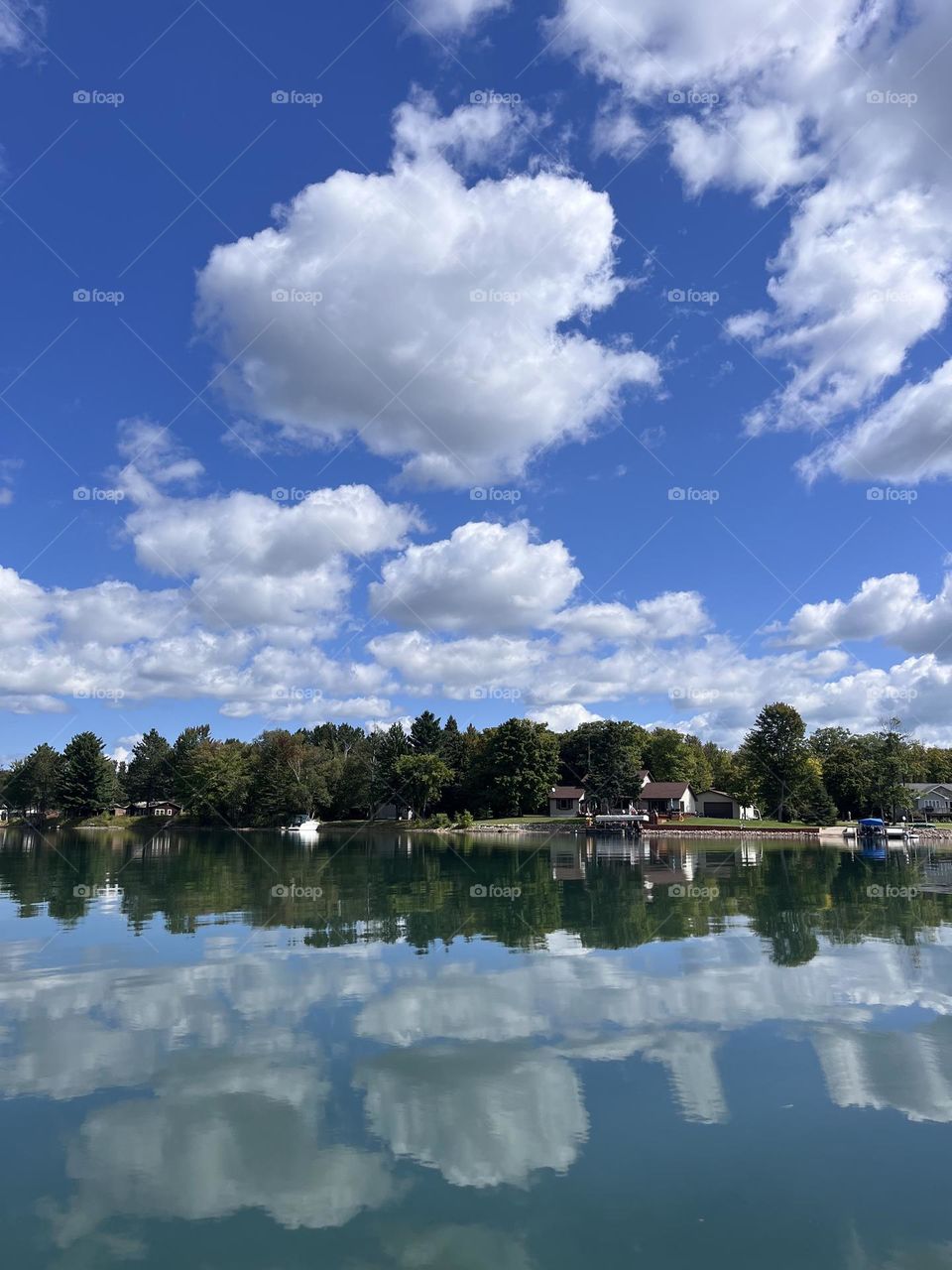 Still lake reflecting blue sky 