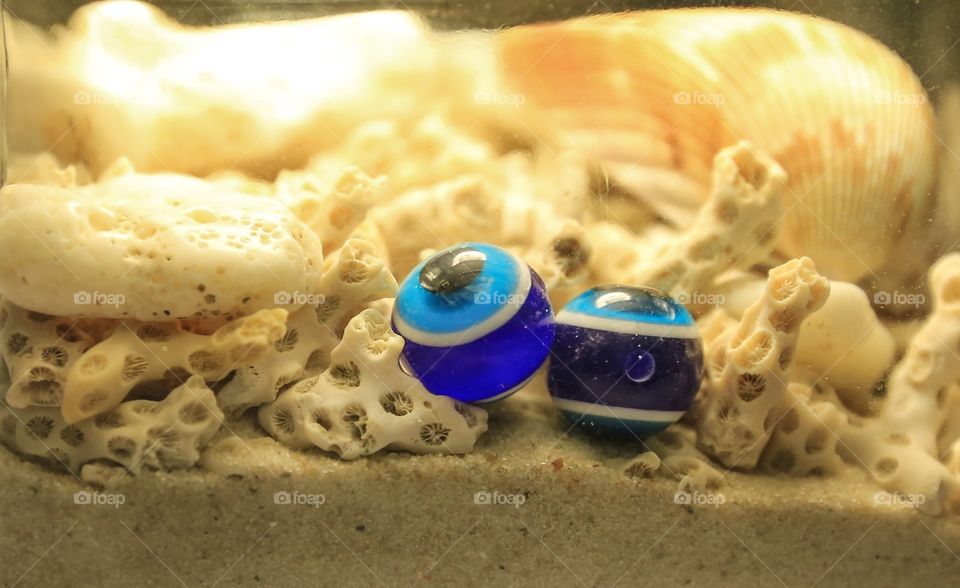 Corals and Sand in a Jar. We love collecting corals at Florida beaches. Makes great decorations in a jar with some evil eyes. 