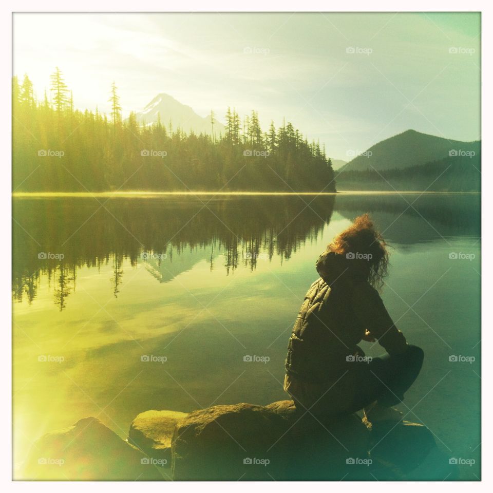 A camper enjoys an early morning view of Mt. Hood from Lost Lake, Oregon. 