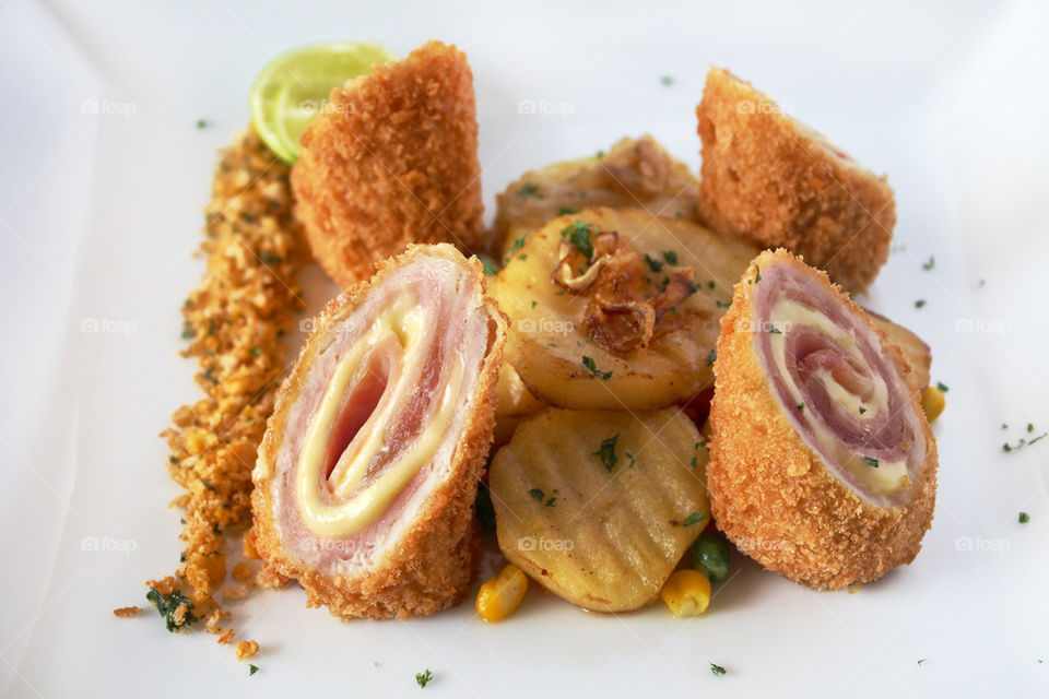 Traditional French cuisine cordon blue with potatoes. Ham and cheese filling