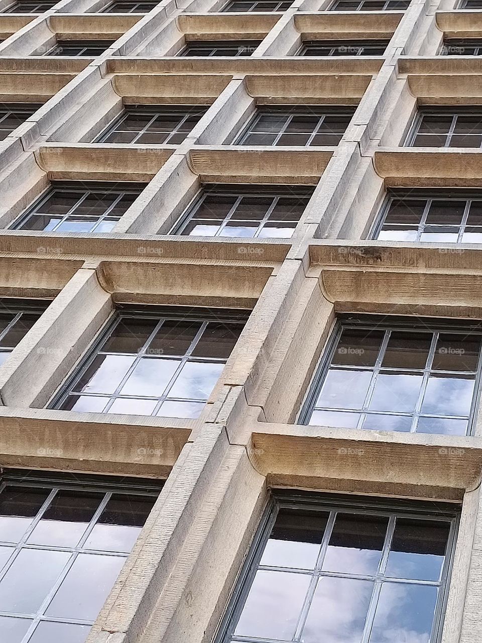 Front of windows with reflection of a cloudy sky