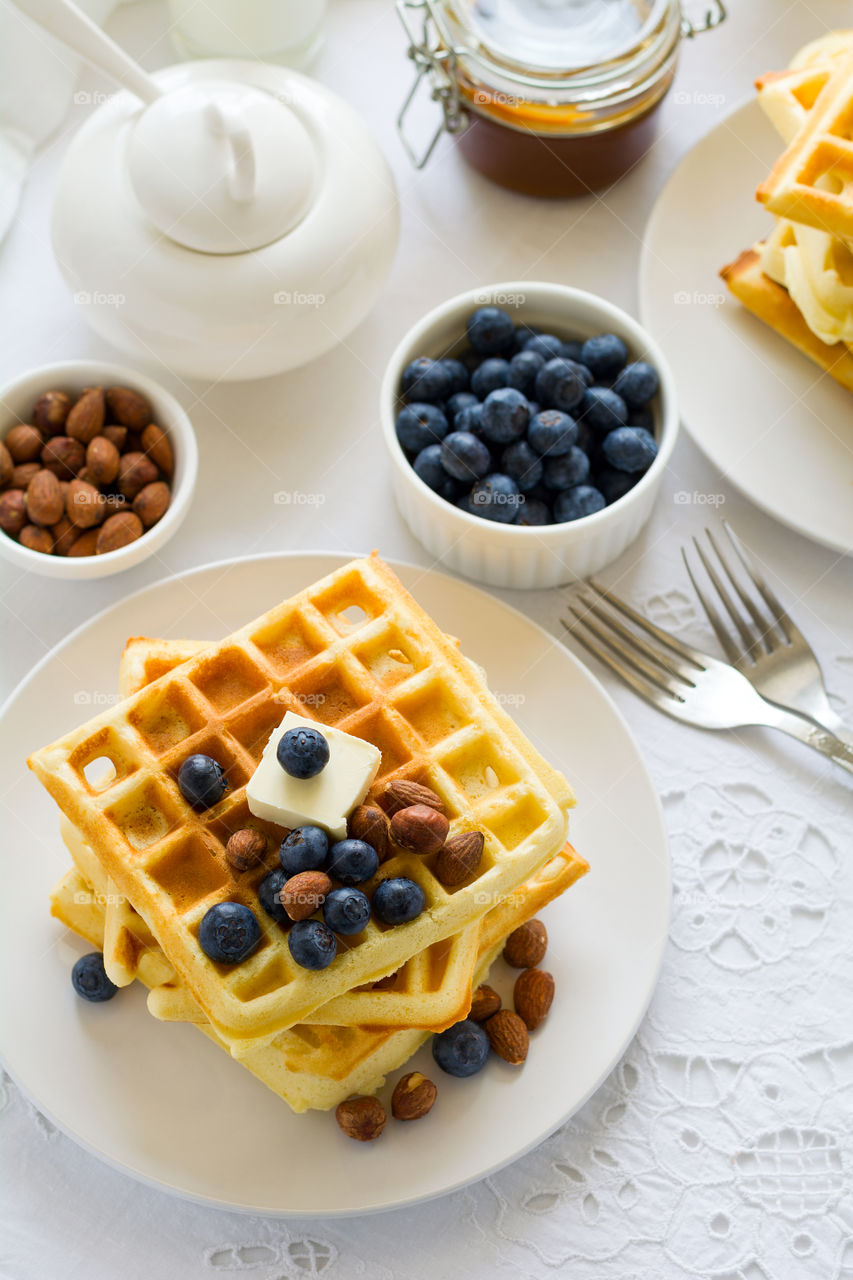 Belgian waffles with butter, blueberry and nuts