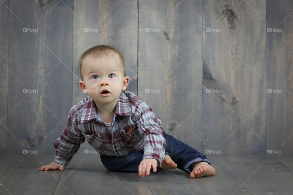 Portrait of a baby boy on wooden floor