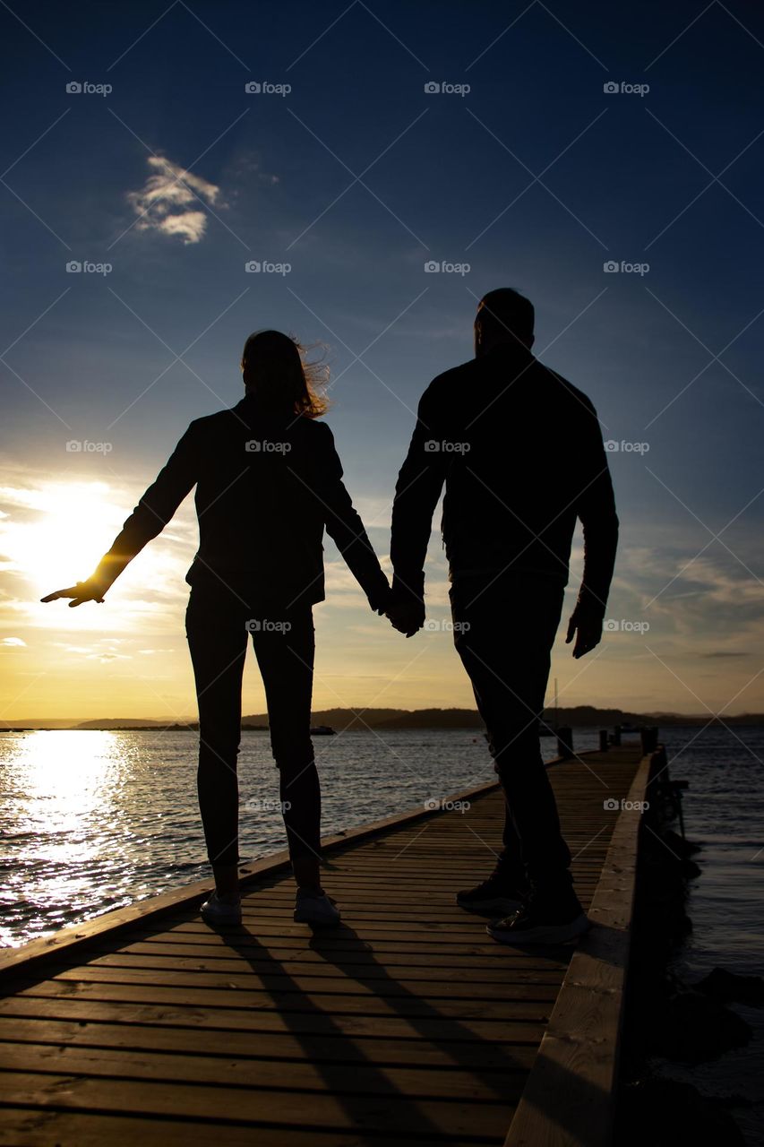 Romantic couple in the SUNSET.
Hand in hand at the Beach.
Simouetts against the sun.