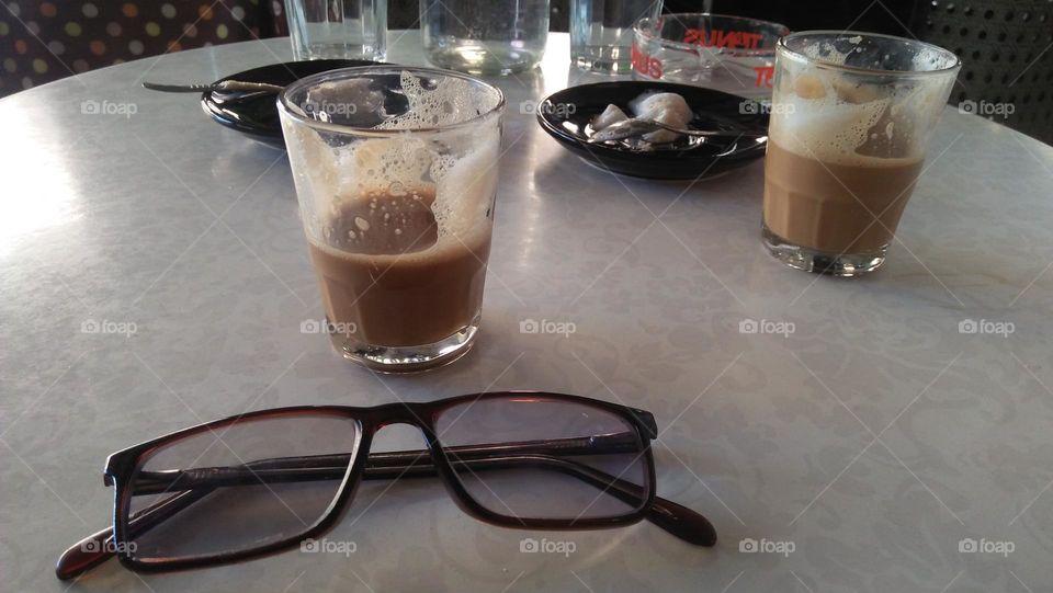 my cup of coffee and my glasses on table.