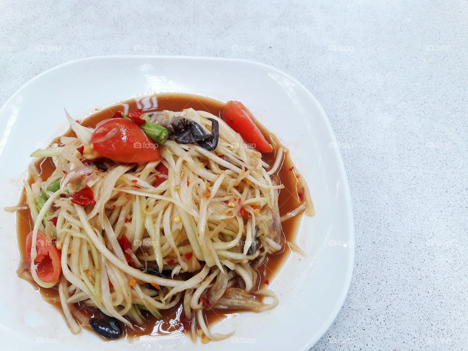 papaya salad on white plate