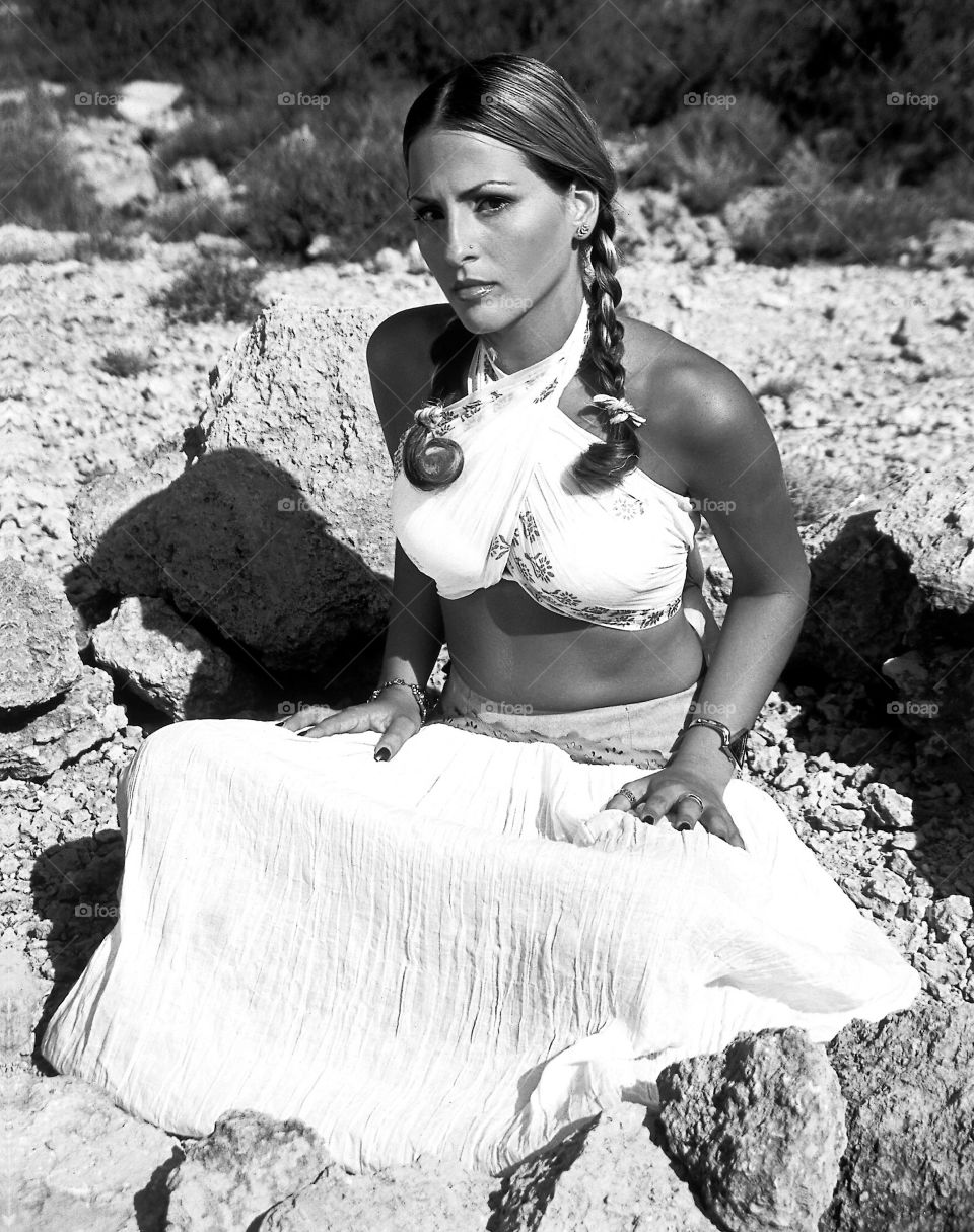 Portrait of woman sitting in stone