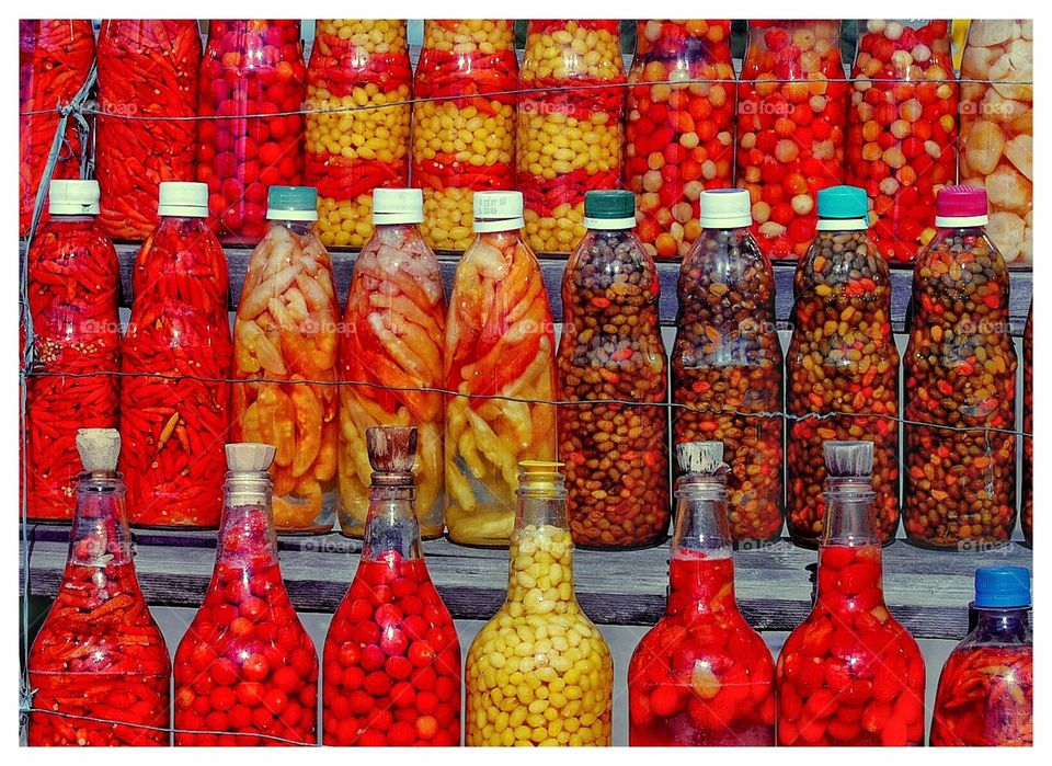 bottles with various peppers in a street market