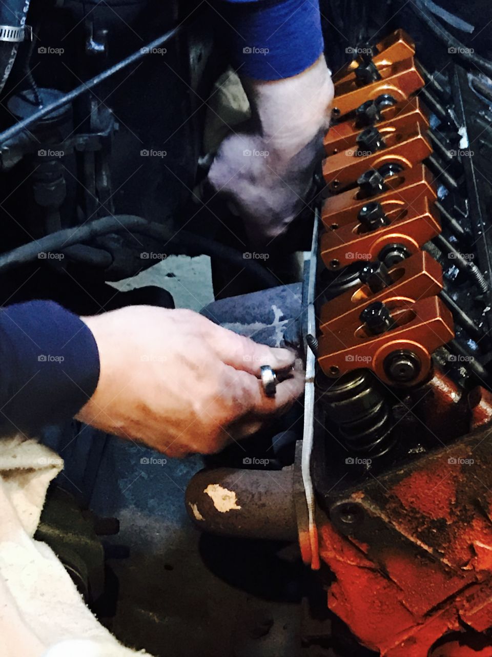 Hands working on engine