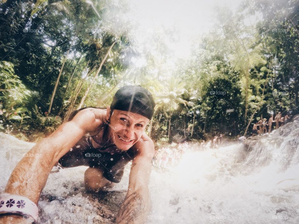 Portrait of young near waterfall