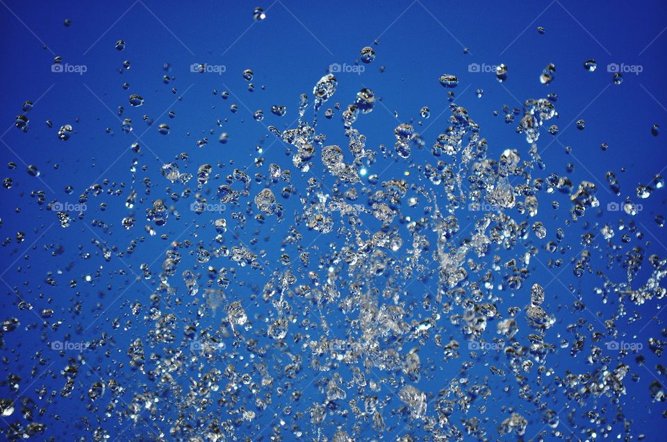 water in motion - water drops on the blue sky background