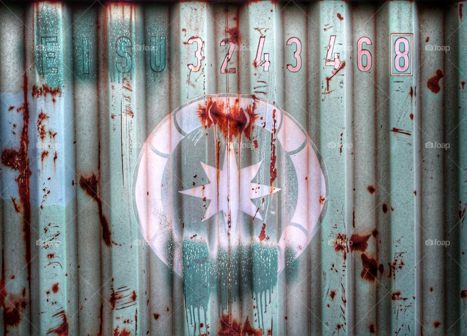 A mysterious symbol on the side of a large metal container.