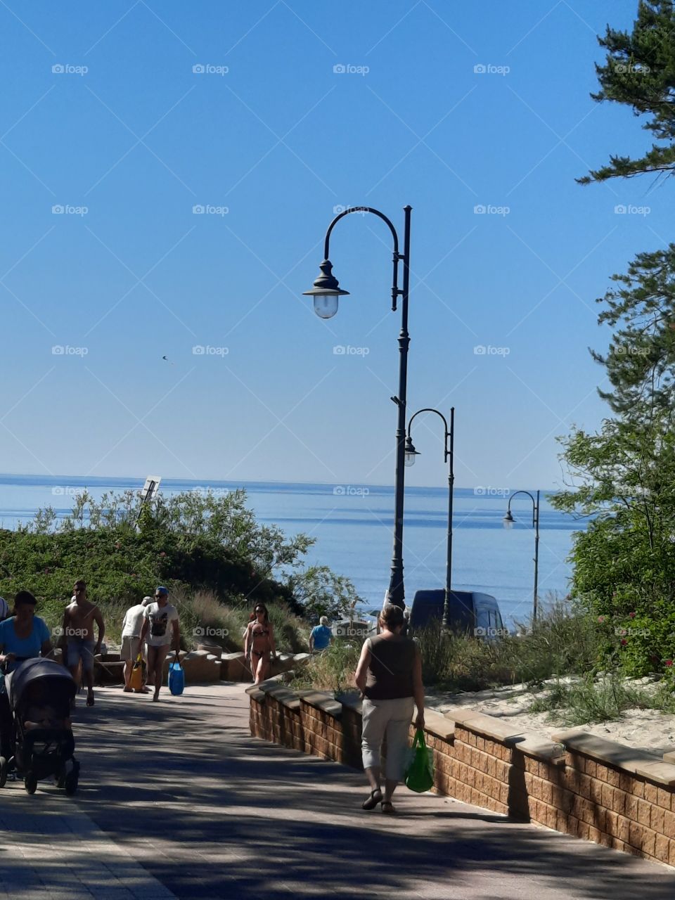 promenade to the beach on a sunny summer day