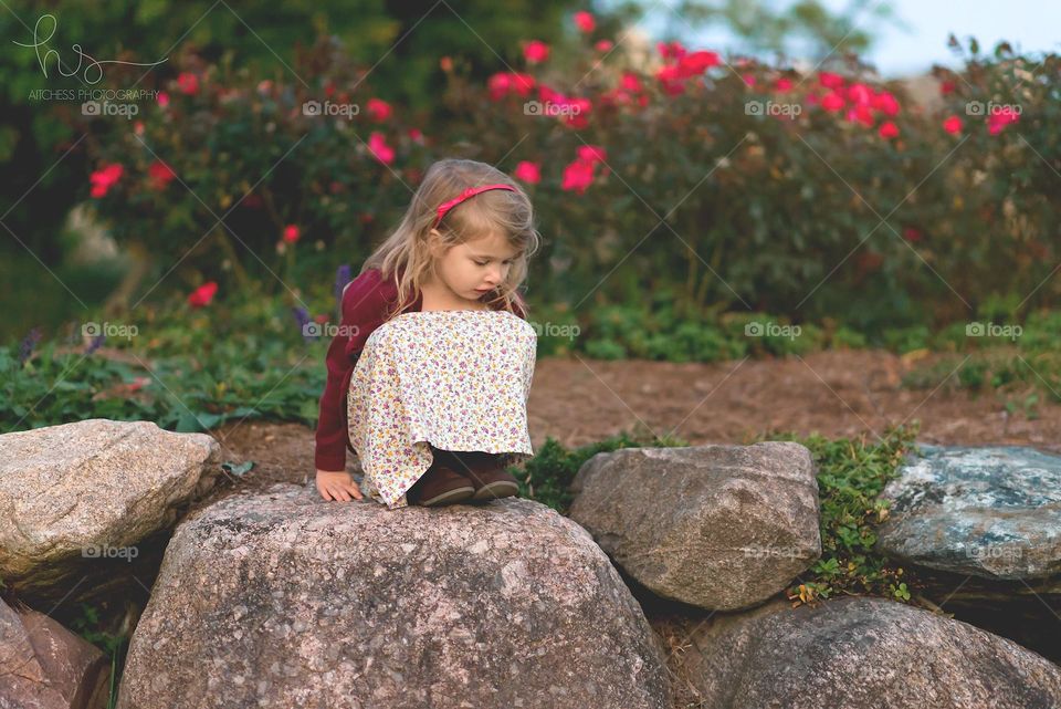 Girl in dress on rocks