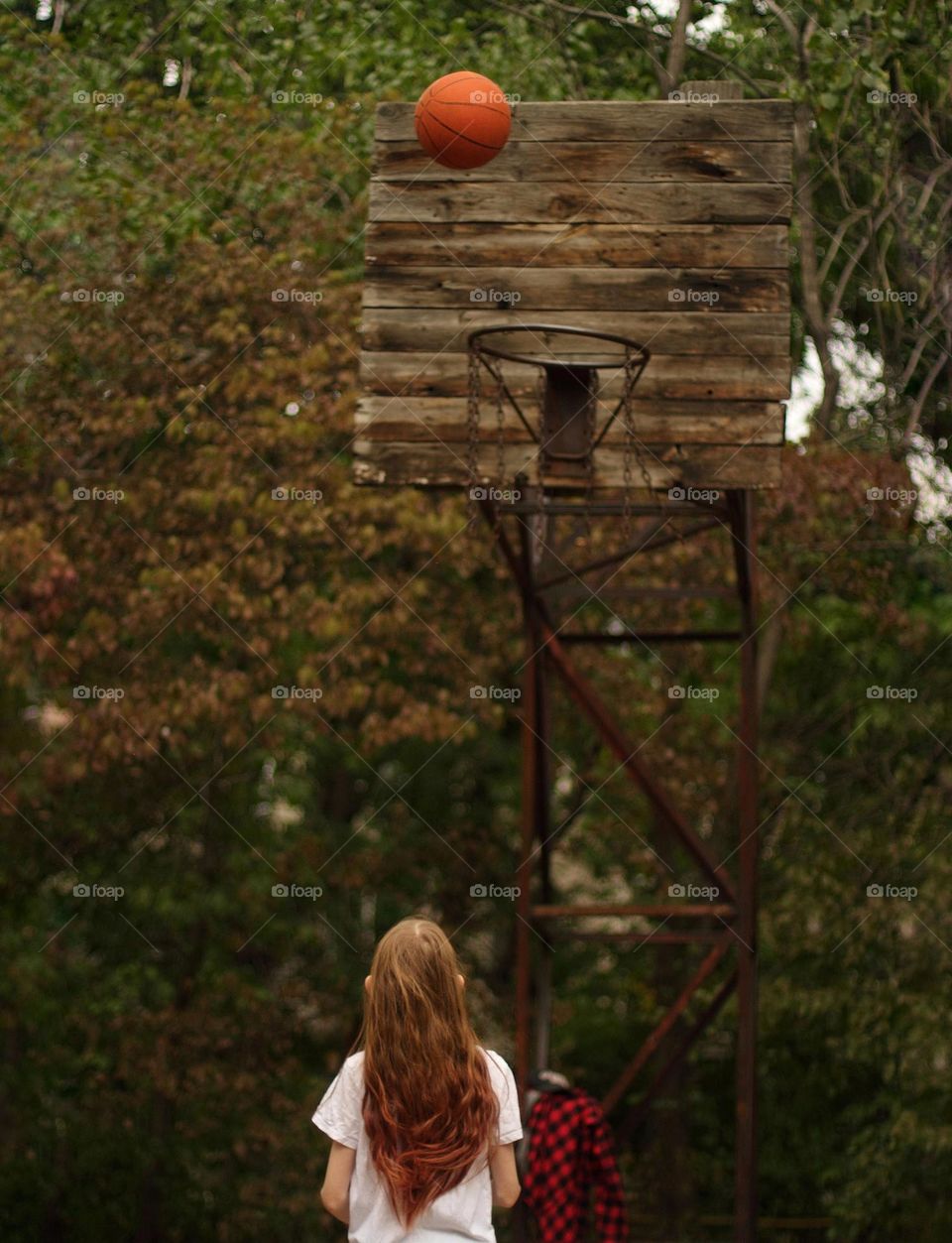 Girl playing basketball in the yard