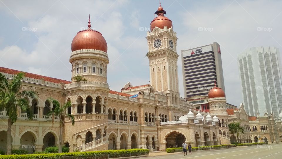 Under fair weather, walking along Malaysia's historical building of Sultan Abdul Samad.