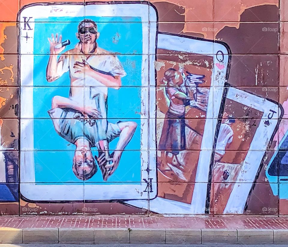 A mural based on playing cards, King, Queen and Jack on a wall in Spain