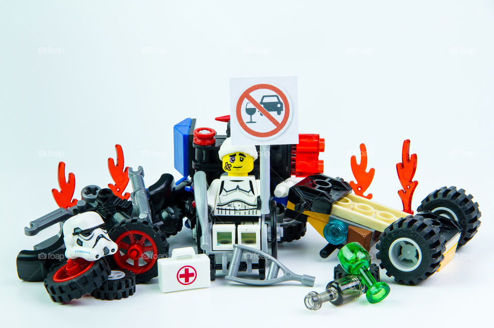 Nonthabure, Thailand - August, 08, 2016 : Lego star wars accident by a drunk driver. holding a sign Drink don't drive isolated on white background.Lego is an interlocking brick system collected around the world.