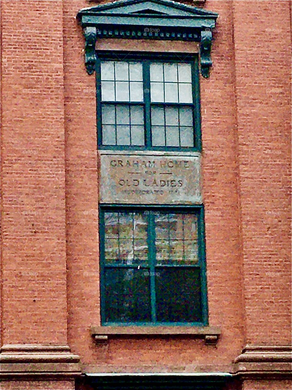 A closeup on the plaque with the inscription “Graham Home for Old Ladies”, an old fashioned brownstone building in in Forest Greene, Brooklyn, NY photographed in 2020. Hypnotic Productions