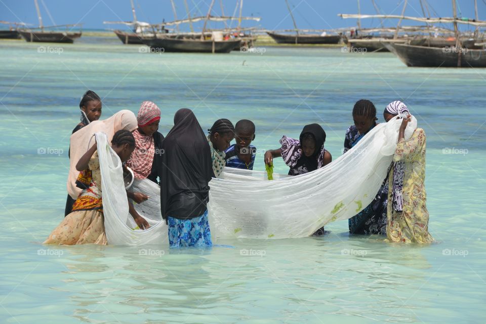 Women fishing off the beach in Zanzibar 