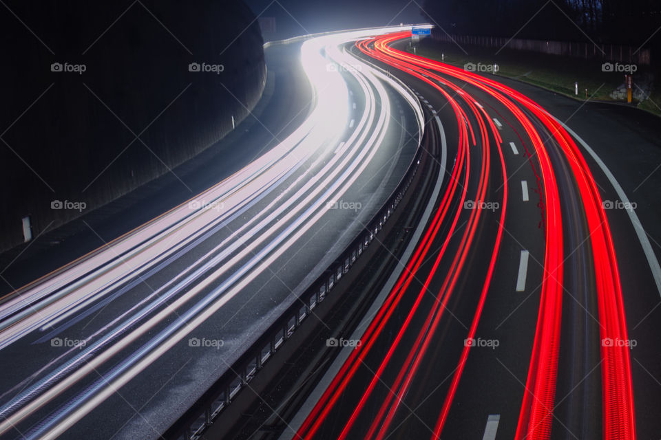Curved Light trails on highway from above