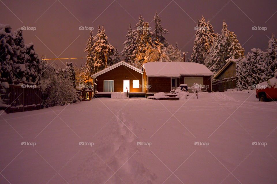 House covered with snow on snowy landscape