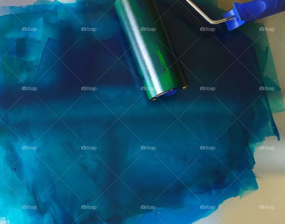 Rubber Roller over Blue Paint in an Artistic Project