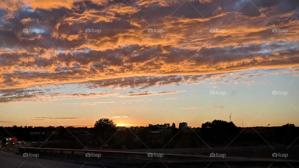 Beautiful golden sunset among the city silhouette