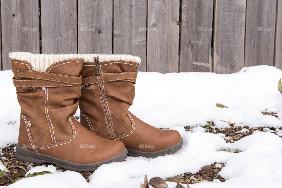 Pair of women's boots in the snow outdoors