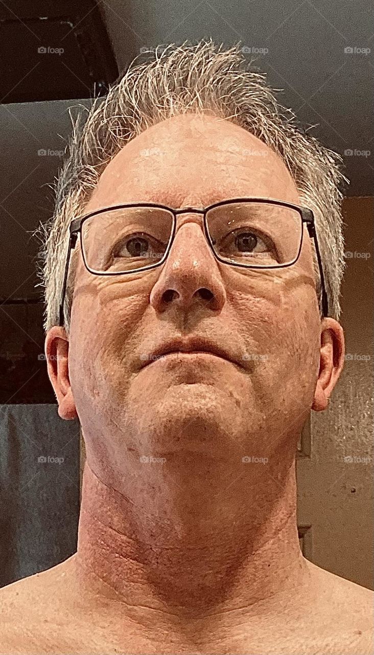 Clean, shaved and ready to take on the world. A neutral expression on a middle-aged man.