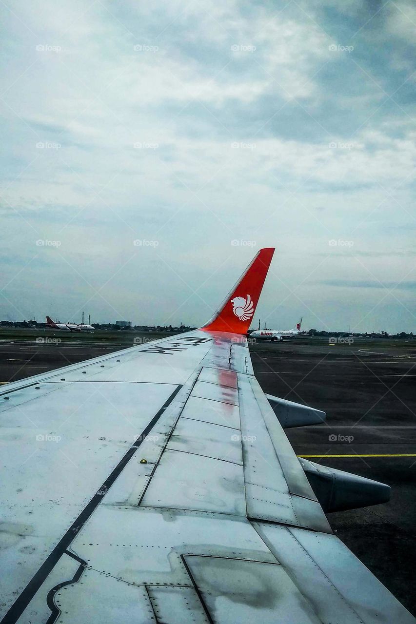 Airplane wings taking off in eye level view