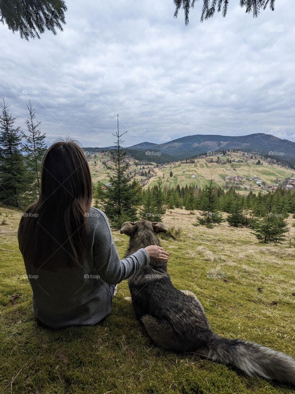 Girl with dog in the mountains