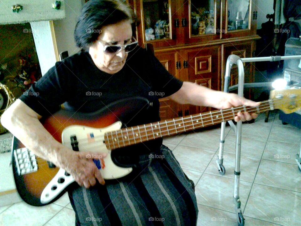 Grandma rocking around.
She is 84 years old and was a bit down because she was missing Lody, the beloved family dog who had passed away some months before. So her son let her play his bass, to cheer her up. Just like him, she loves rock and motorbikes. Cool granny! :)