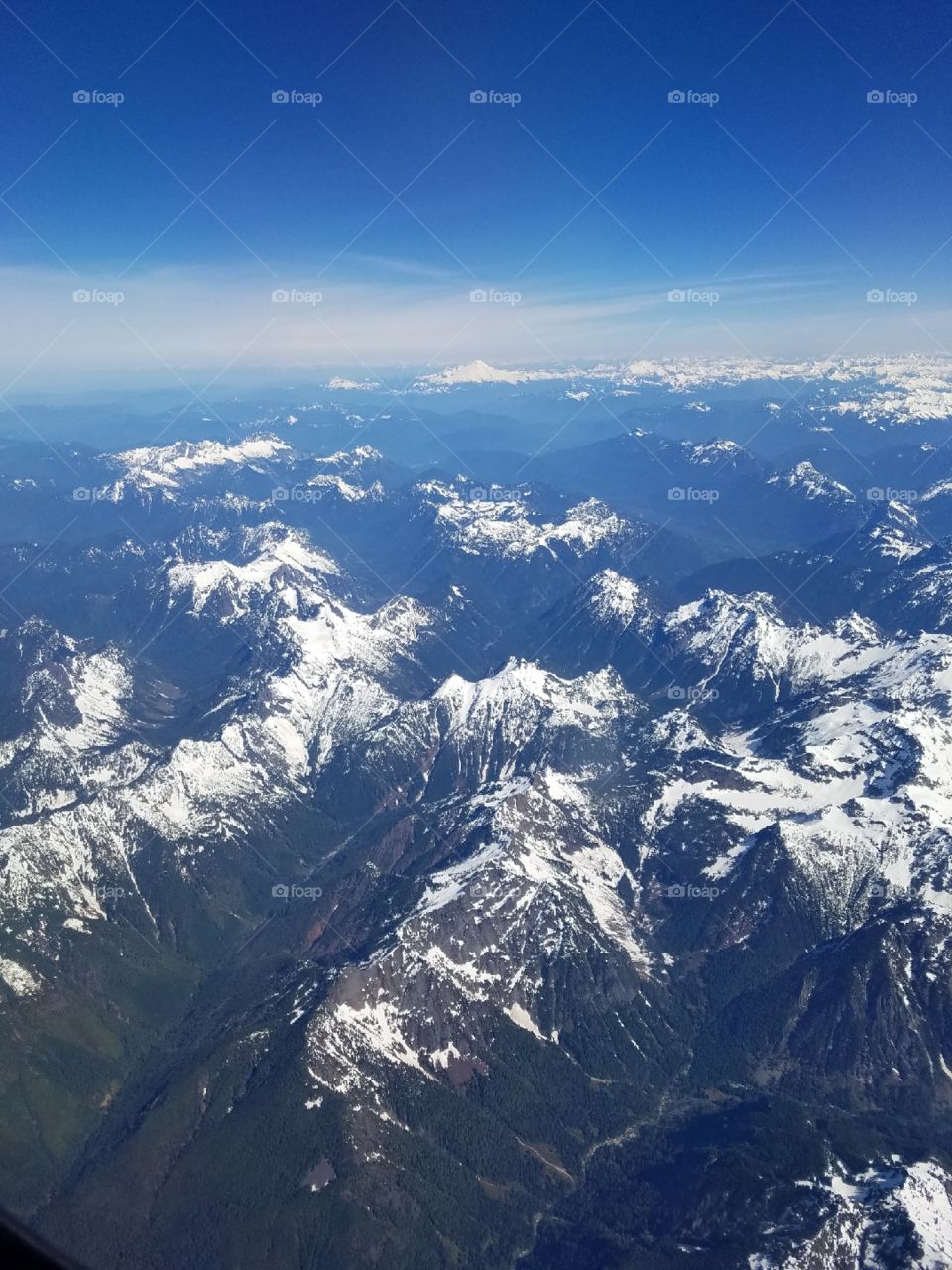 View from airplane snow capped mountains Nevada 