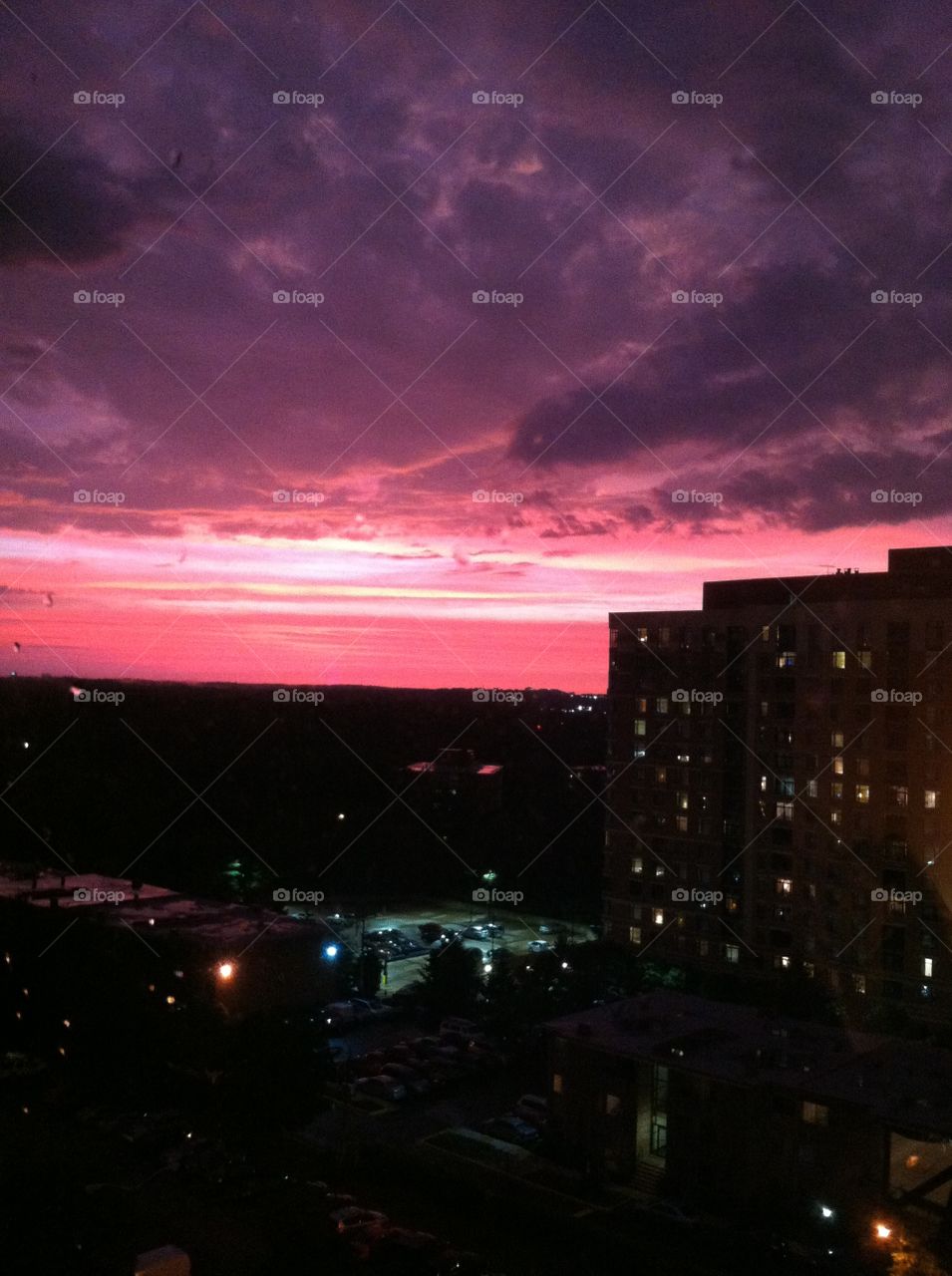 Red sky with storm clouds . Stormy weather over the city at night 