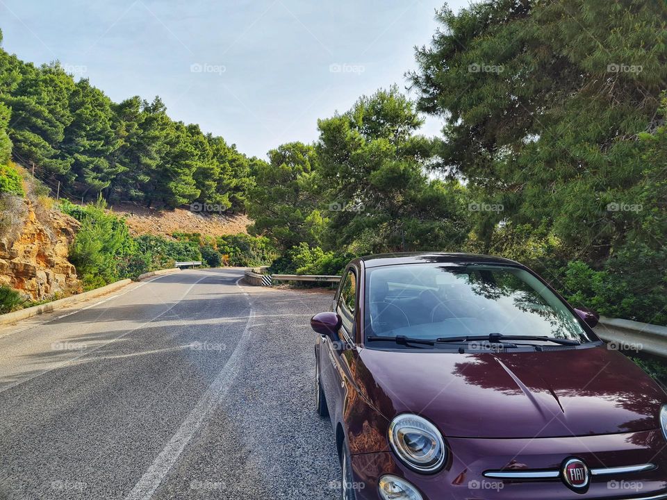 Italian car of the FIAT 500 stopped on the road