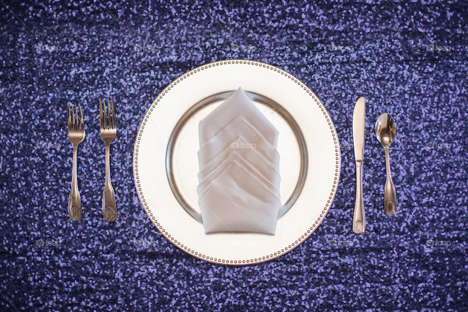 White Plate table setting on blue tablecloth