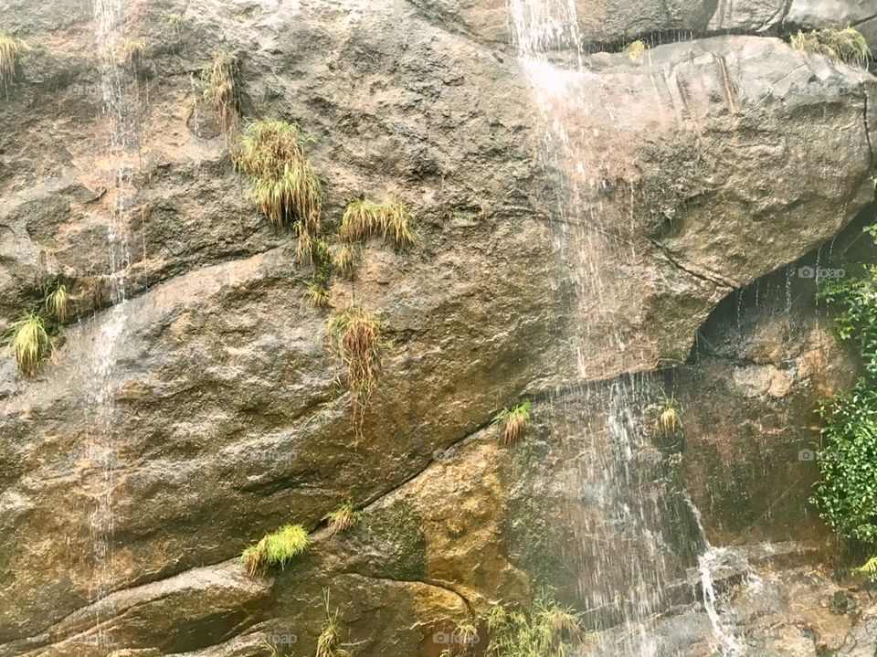 Water falling on a big rock in Sri Sri Lanka 