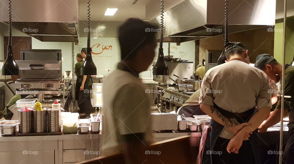 Chefs at work in the kitchen of Cuca restaurant in Bali, Indonesia