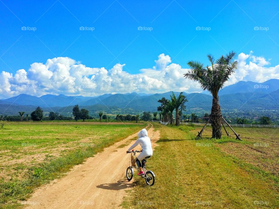 People riding bicycles to travel in beautiful nature.  It is a great holiday and has the power to continue living ahead. Beauty in nature.