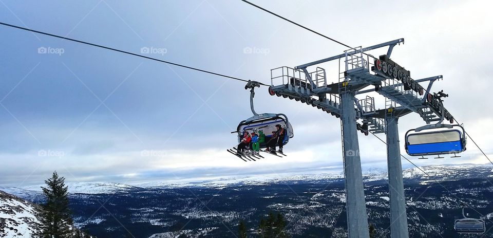 Overhead cable car against sky during winter