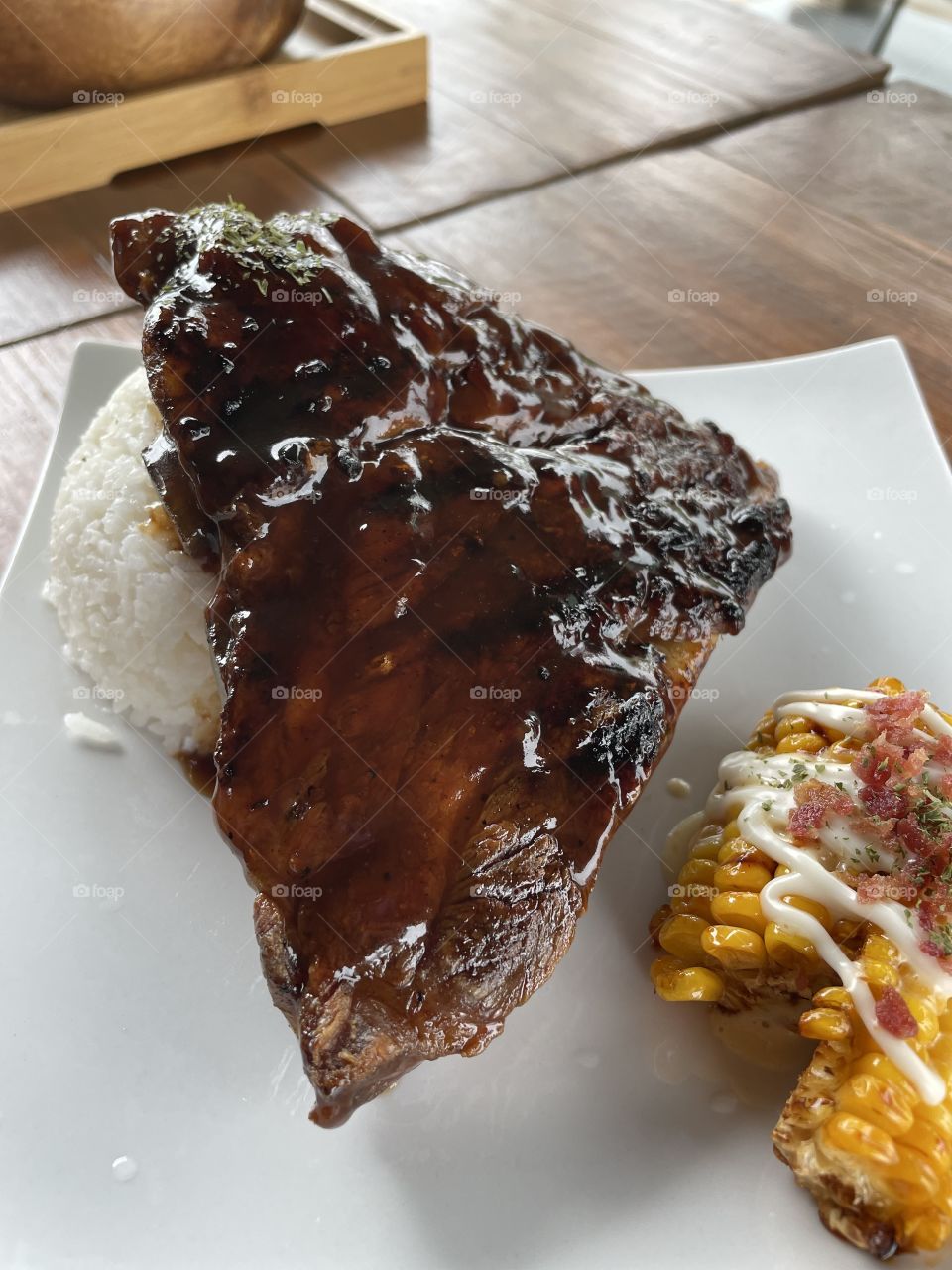 Dinner set of barbecued ribs with rice and corn