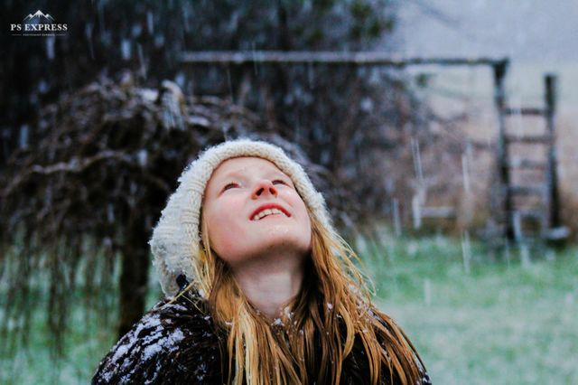 Girl enjoing the first snow of the year.