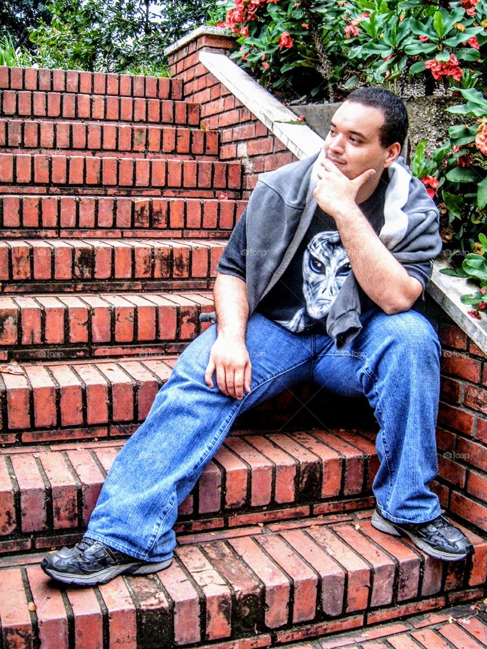 young model sitting in brick stairs