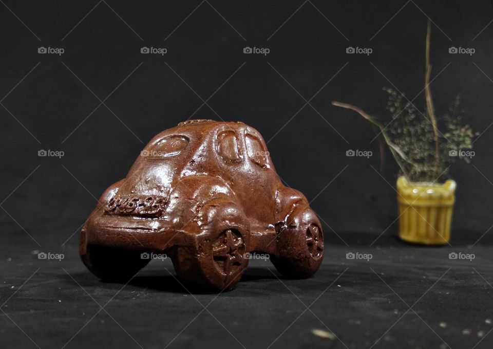miniature of vintage car from clay material.  looks like food, chocolate