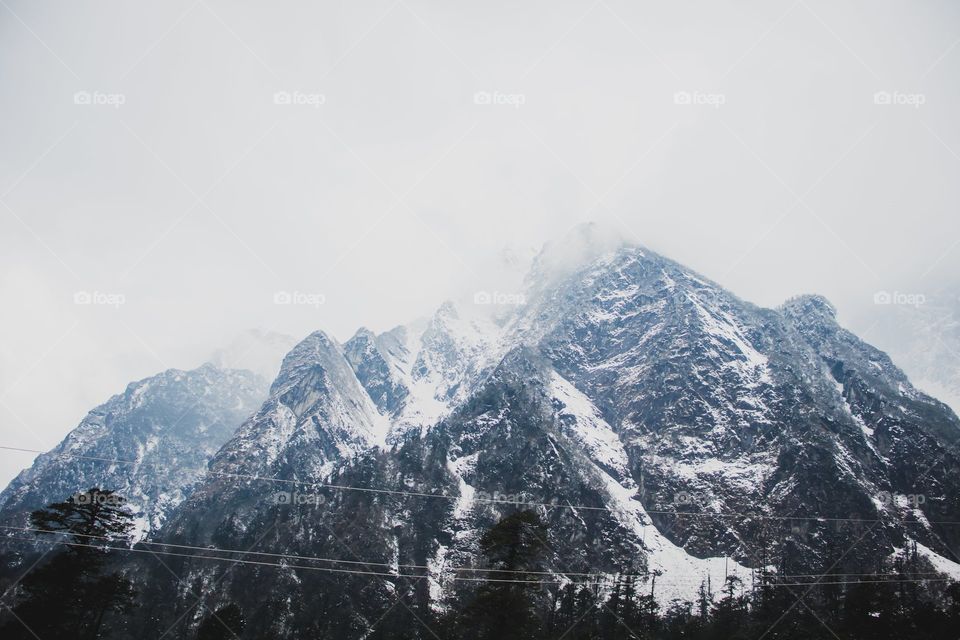 Snow Capped Mountains Covered With Clouds
