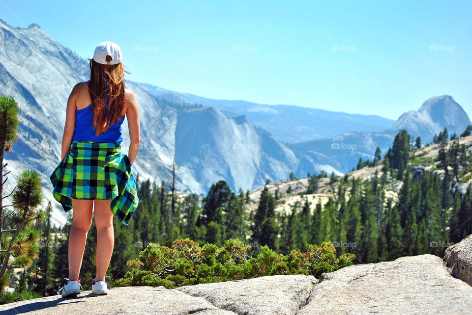 Woman looking at the beautiful view of a mountain/ canyon/ after a hike