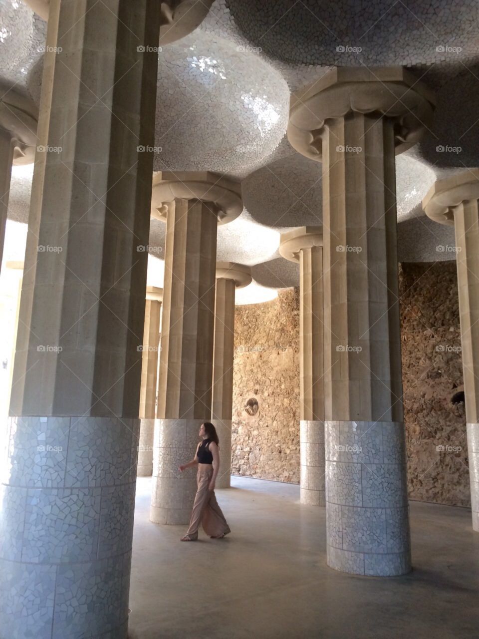 View of column in building and woman walking