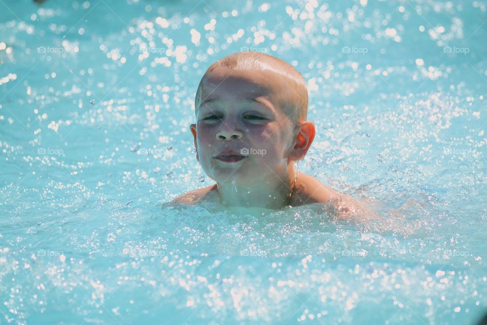 Boy playing in a pool